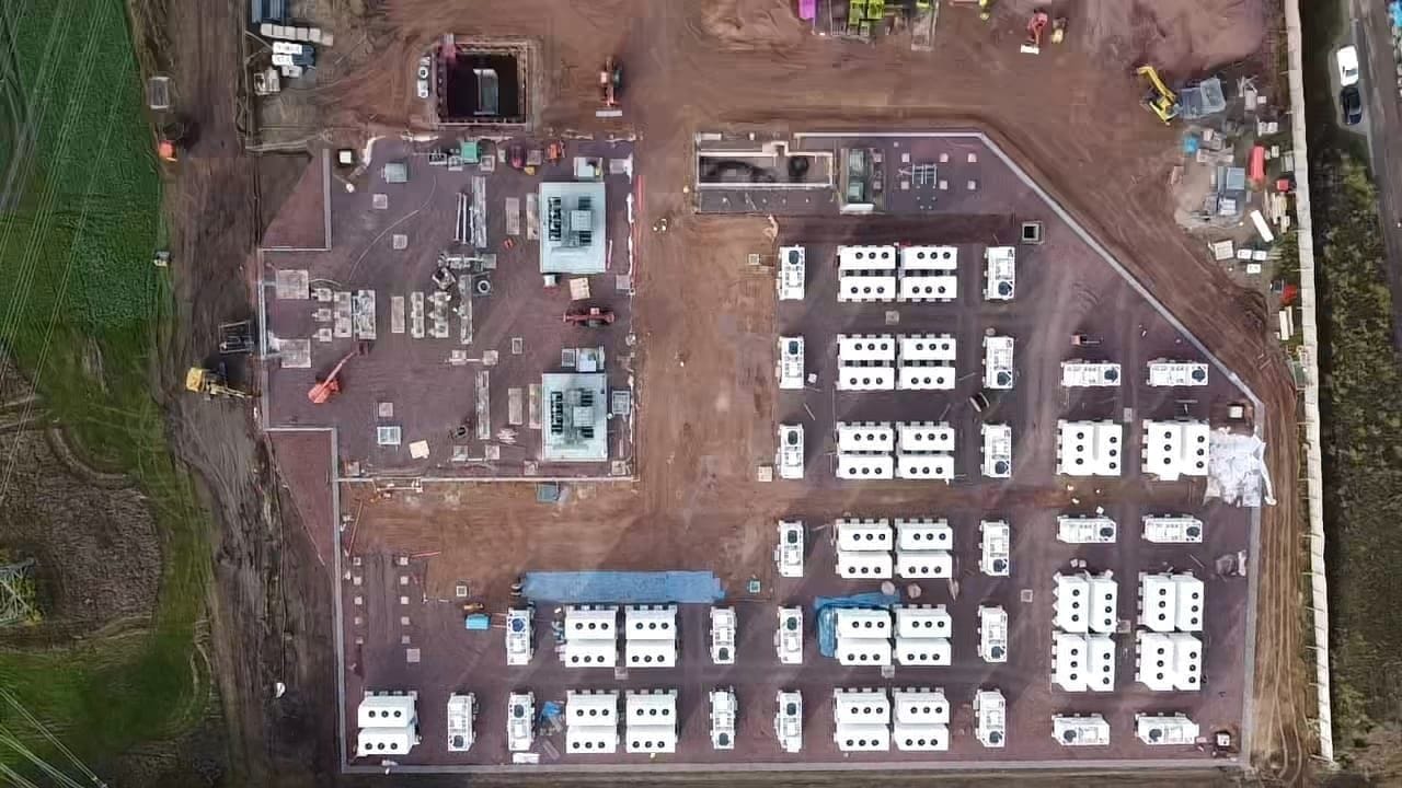 A top-down aerial survey view of a Maveric construction site, with electrical and battery units laid out across the platform.